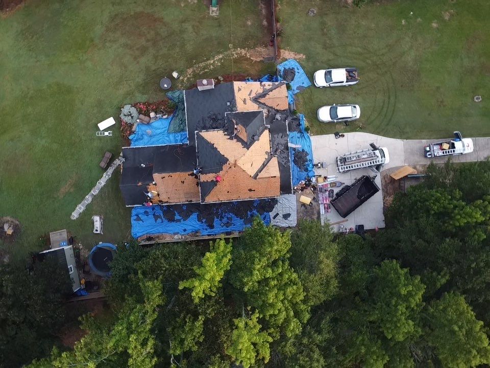 Aerial view — tear-off and re-roofing in progress