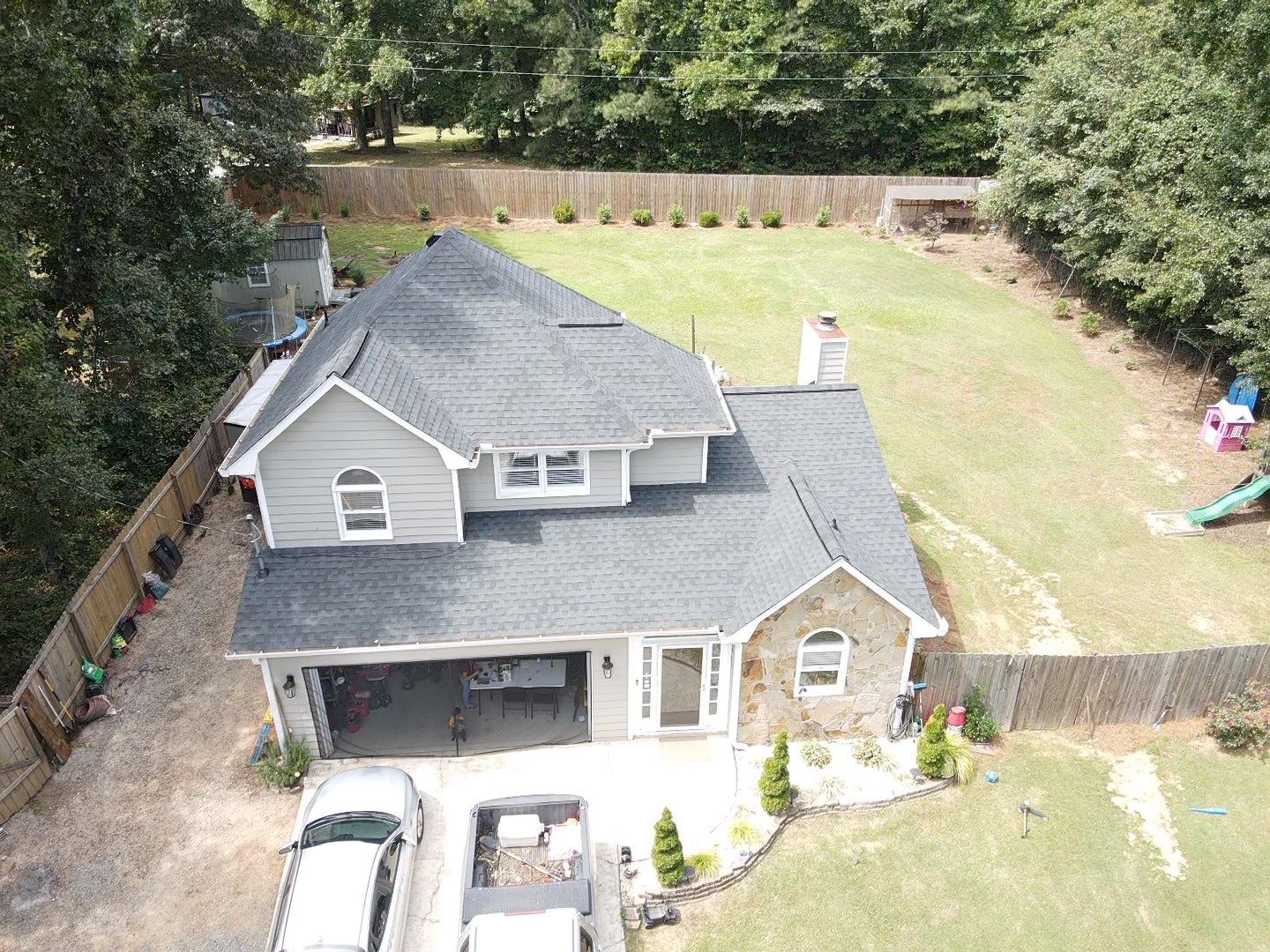 Completed residential roof — aerial backyard view